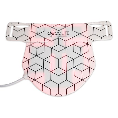 A white, geometric-patterned LED mask with pink lights beneath—Rio’s décoLITE Anti-Ageing Light Treatment for radiant skin—with a cable on the left side.